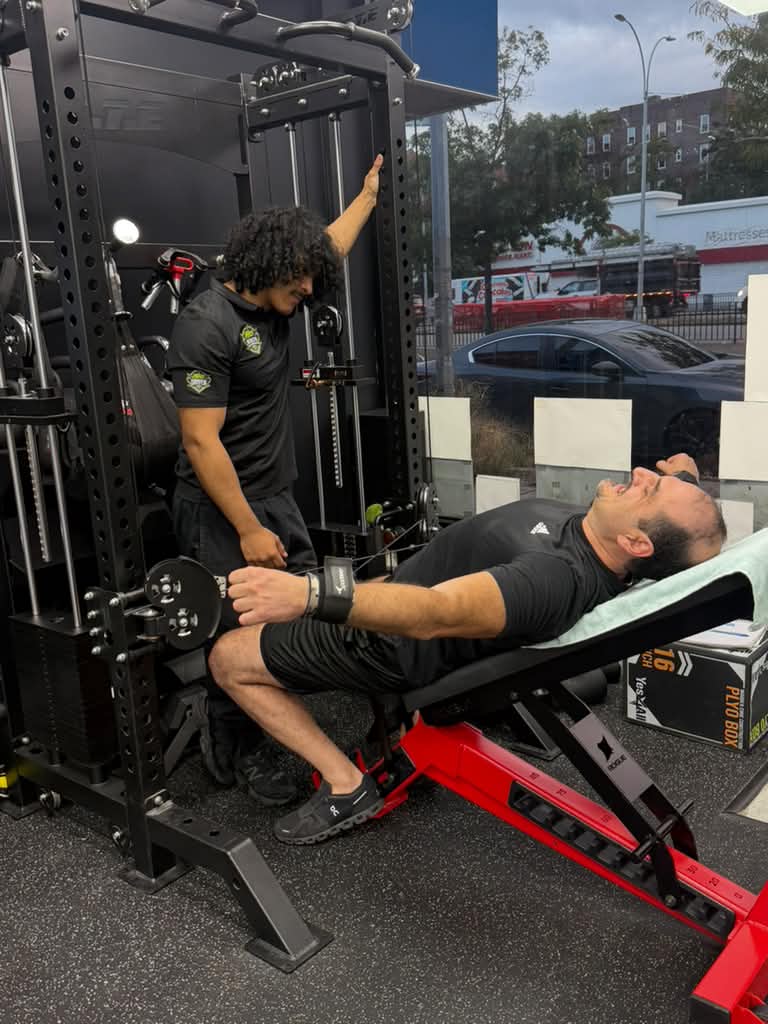 Angel coaching a client during strength training