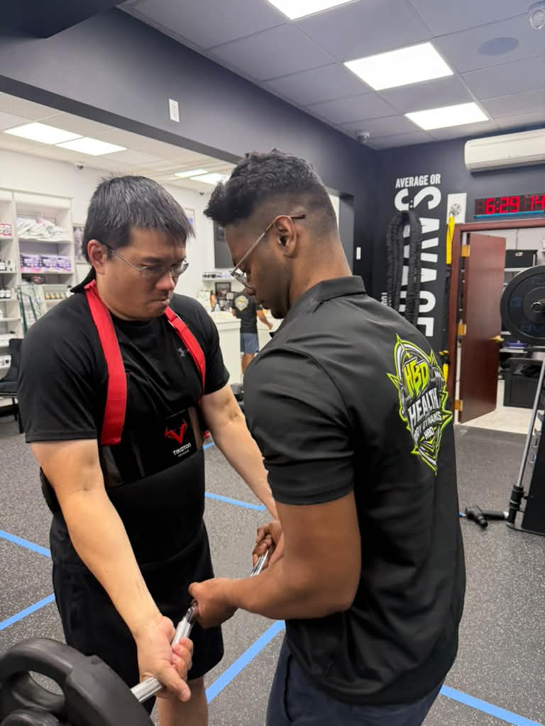Bishu coaching a client during strength training