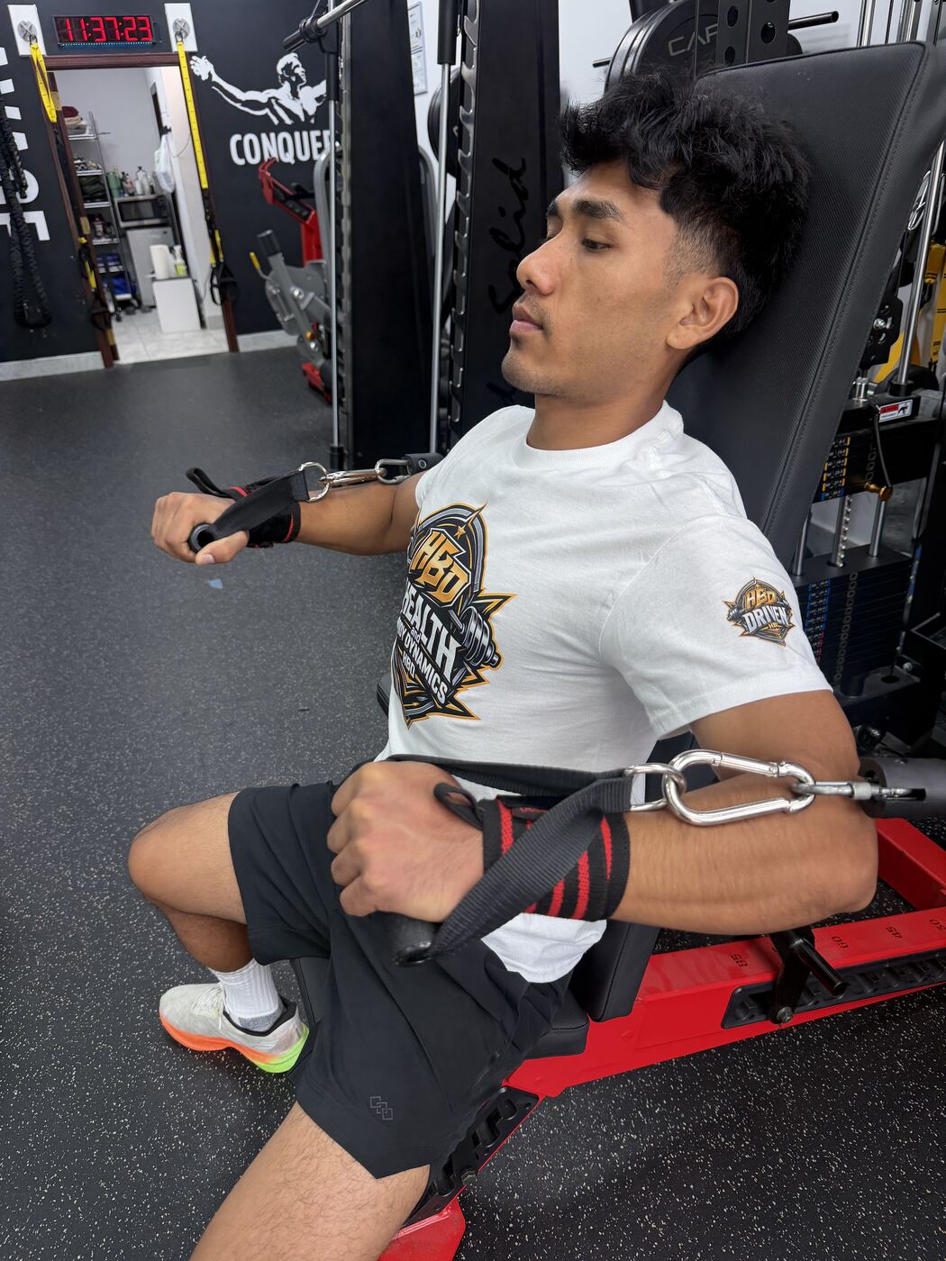 HBD trainer working with a client on cable resistance equipment